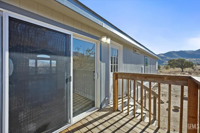 a balcony view with a glass door