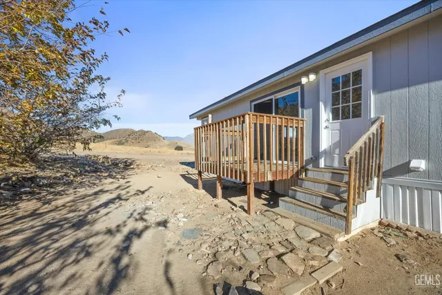 a view of wooden house with a wooden fence