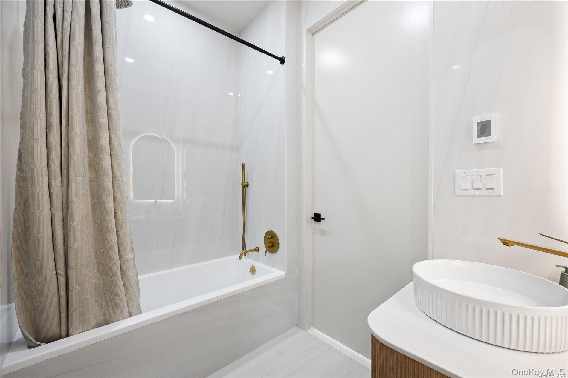 31-16 21st Street, Unit 3A Queens, NY 11106 - Photo 12 of 14 a bathroom with a sink and a mirror