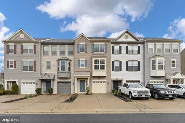 a car parked in front of a big house