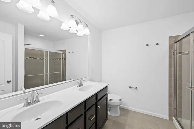 a bathroom with a glass shower door