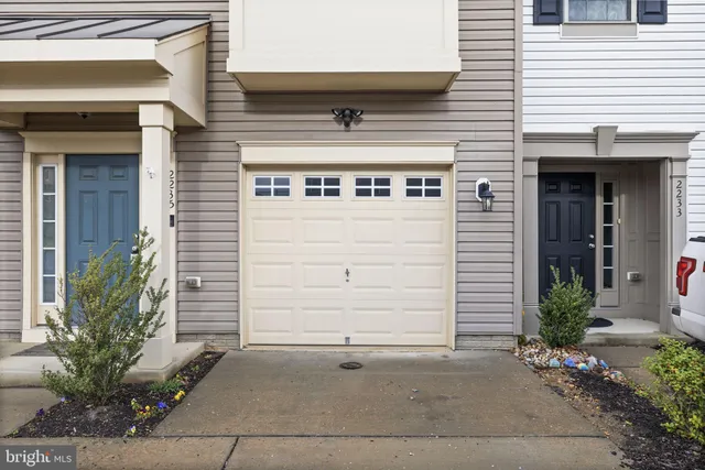 a front view of a building with potted plants