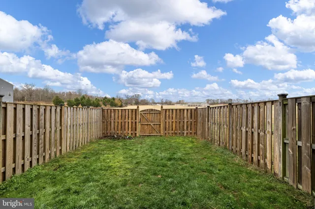 a view of a garden with wooden fence