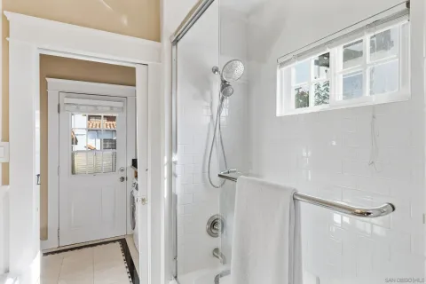 a bathroom with a glass shower door