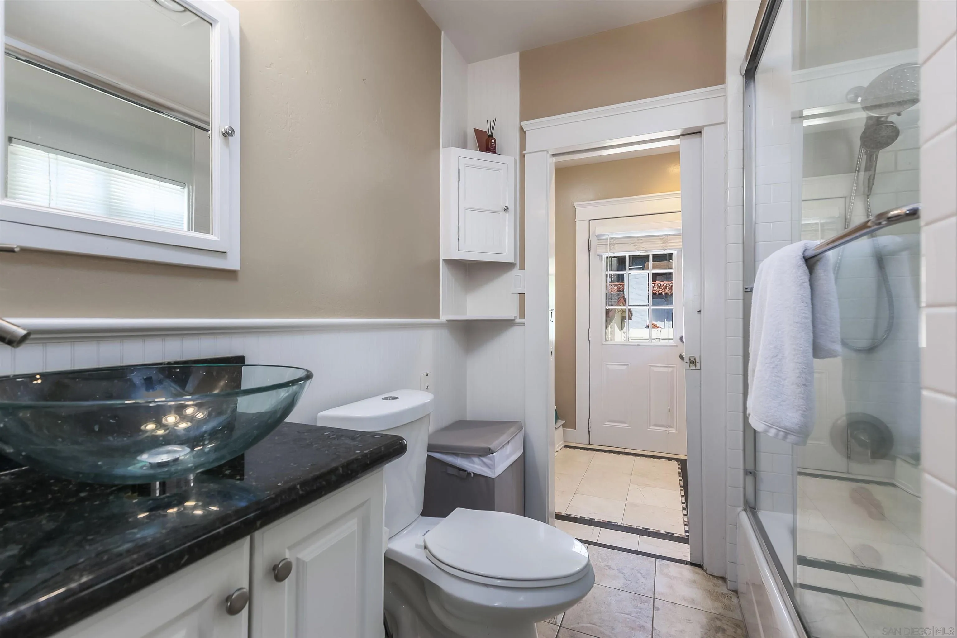 2544 Juan Street San Diego, CA 92110 - Photo 18 of 54 a bathroom with a granite countertop toilet a sink and a shower