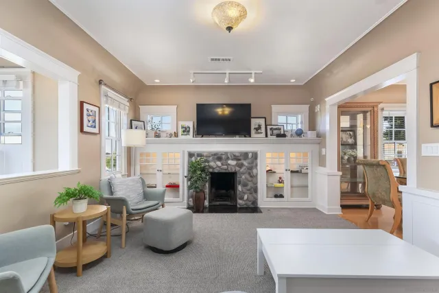 a bedroom with a bed and a refrigerator