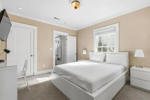 a bedroom with a bed and a lamp