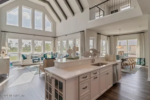 a view of a kitchen counter top space with furniture and wooden floor
