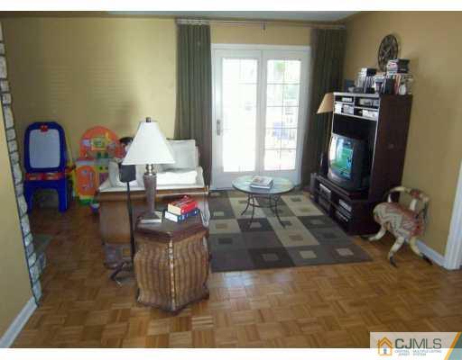 168 South Hill Road Colonia, NJ 07067 - Photo 2 of 8 a living room with furniture a window and a flat screen tv