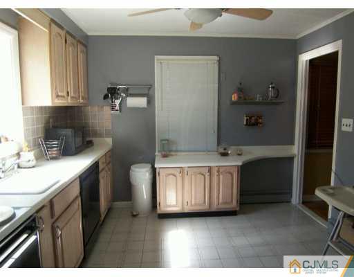 168 South Hill Road Colonia, NJ 07067 - Photo 4 of 8 a kitchen with a sink stove and cabinets