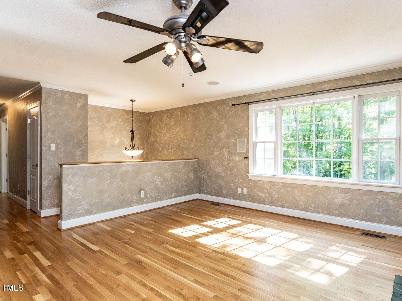 525 Turtle Creek Farm Road Apex, NC 27523 - Photo 9 of 36 a view of empty room with wooden floor and fan