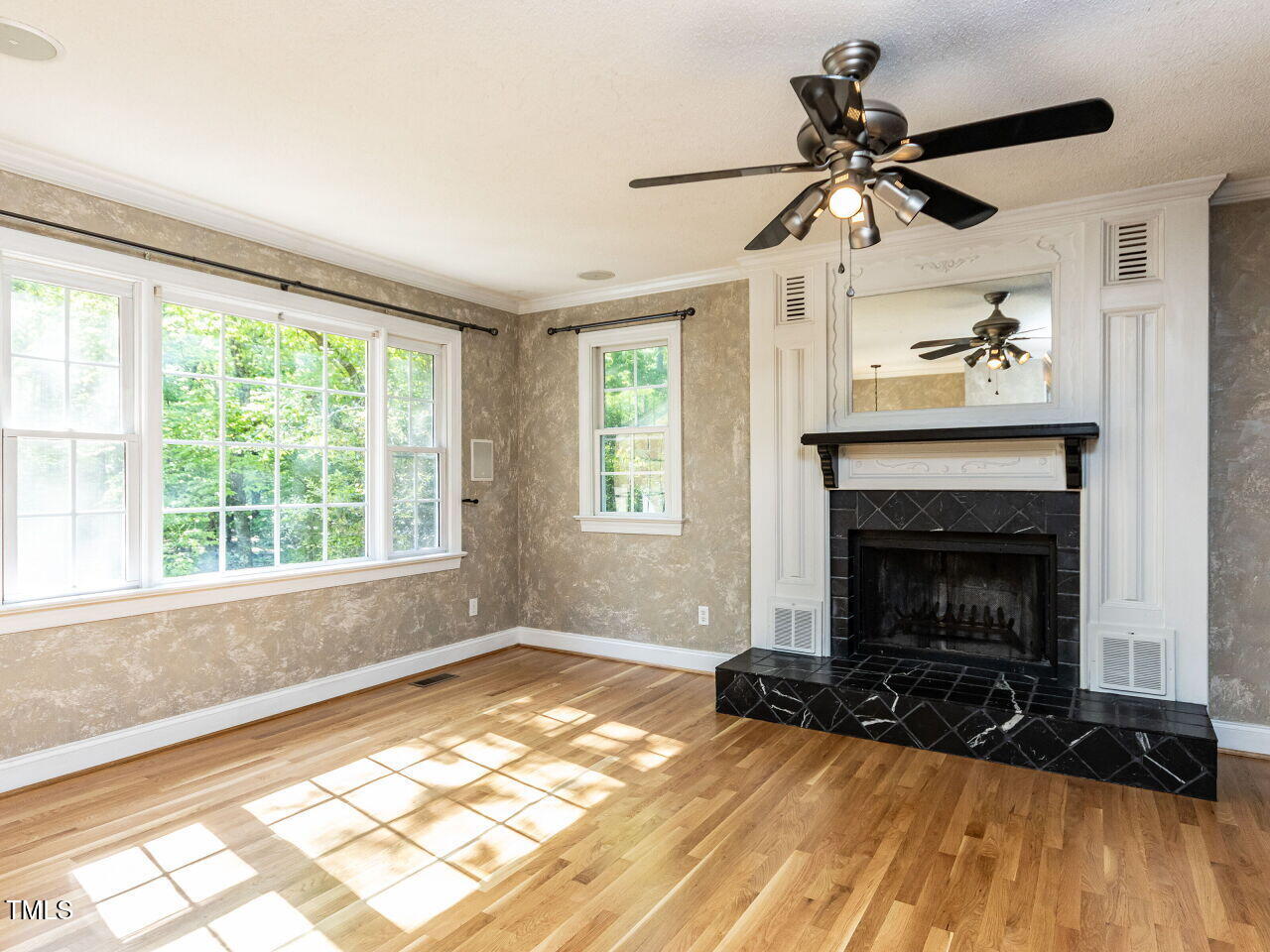 525 Turtle Creek Farm Road Apex, NC 27523 - Photo 10 of 36 a living room with a fireplace windows and a ceiling fan