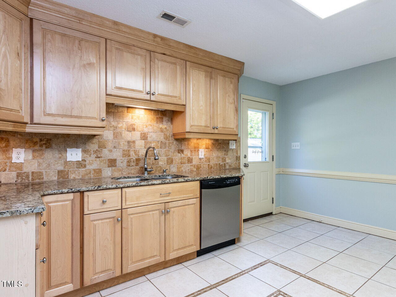 525 Turtle Creek Farm Road Apex, NC 27523 - Photo 13 of 36 a kitchen with granite countertop white cabinets and stainless steel appliances