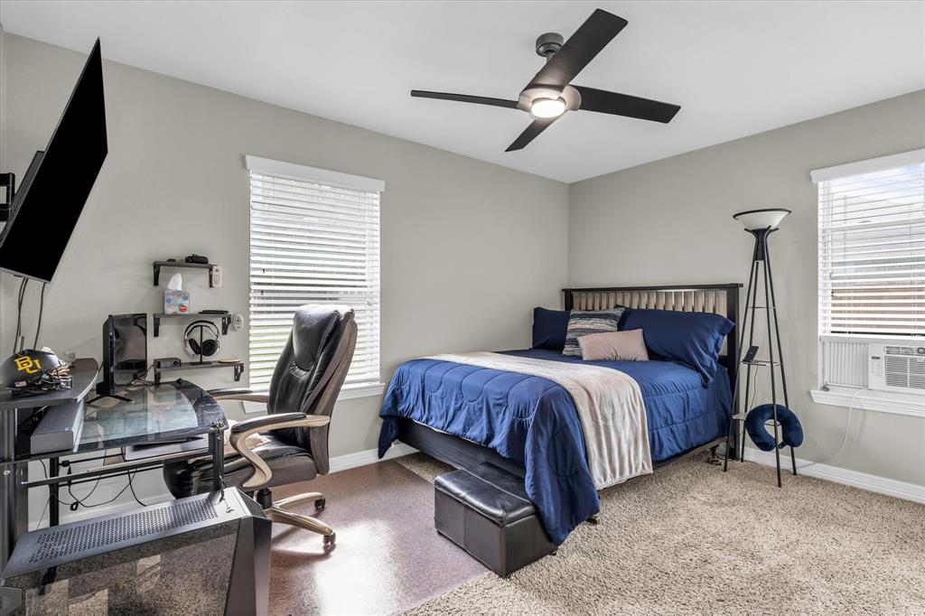 910 Springdale Lane Lorena, TX 76655 - Photo 21 of 39 Bedroom featuring a modern ceiling fan with integrated lighting, two windows with blinds, and light gray wall paint