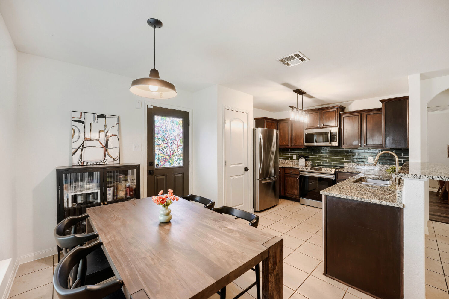 116 Millers Loop Jarrell, TX 76537 - Photo 7 of 23 Gather around the table in this inviting dining area, thoughtfully positioned adjacent to the kitchen for effortless everyday meals and entertaining.