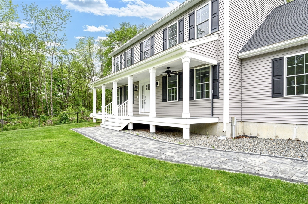 1310 North Brookfield Road Oakham, MA 01068 - Photo 4 of 30 a front view of a house with a yard and porch