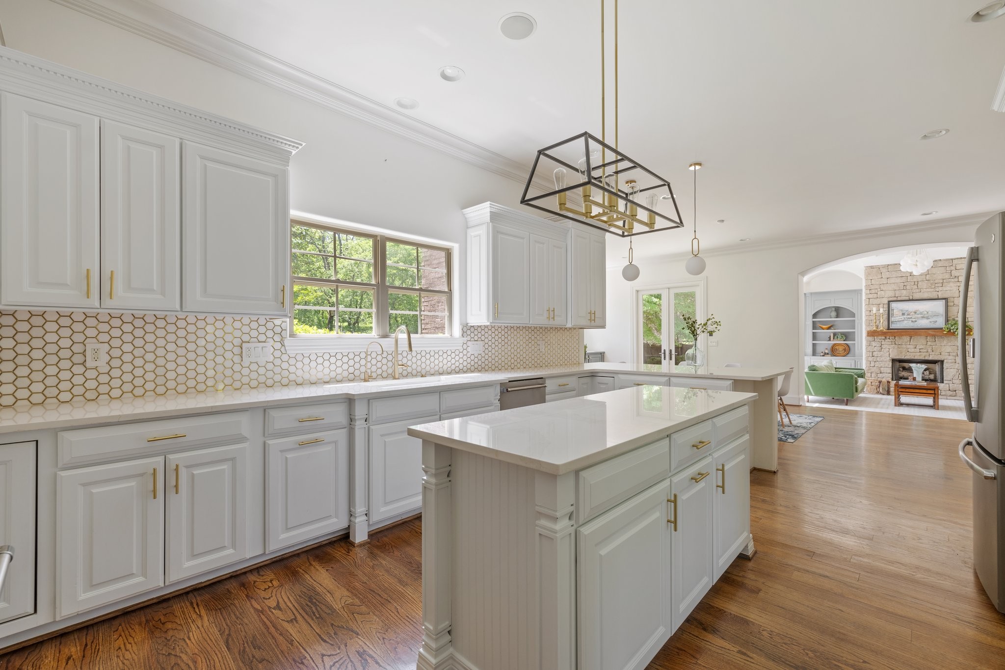 4409 Savage Pointe Drive Franklin, TN 37064 - Photo 19 of 70 a kitchen with a sink dishwasher a stove and white countertops with wooden floor