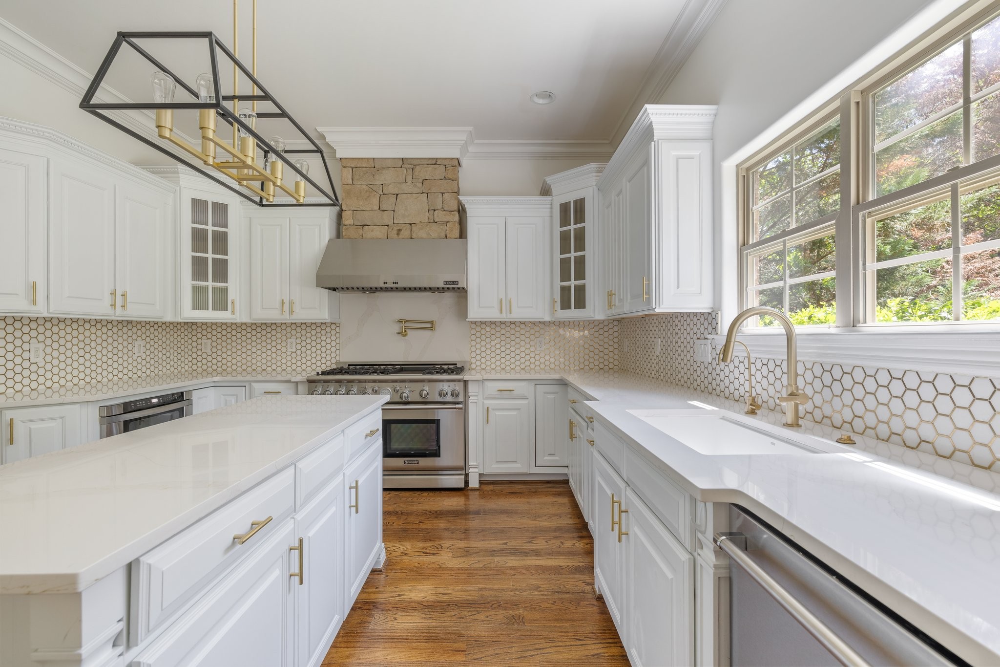 4409 Savage Pointe Drive Franklin, TN 37064 - Photo 21 of 70 a kitchen with a sink dishwasher a stove and white cabinets with wooden floor