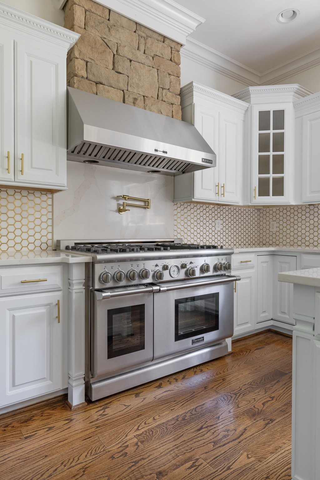 4409 Savage Pointe Drive Franklin, TN 37064 - Photo 26 of 70 a kitchen with stainless steel appliances a stove and white cabinets with wooden floor