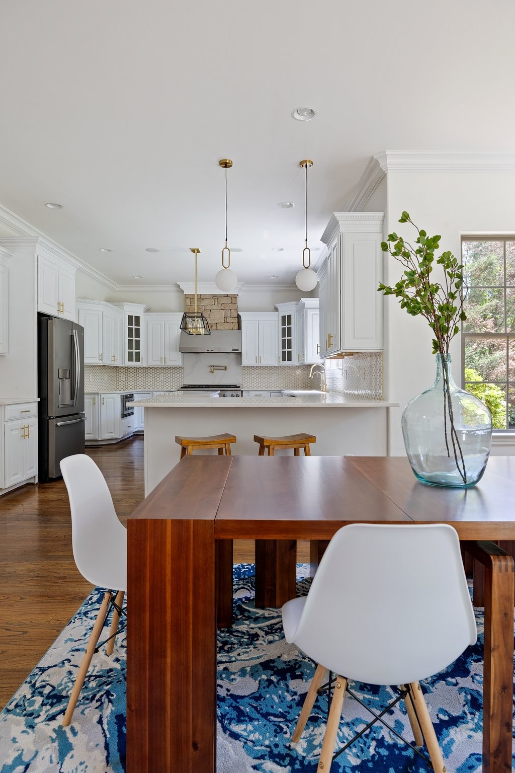 4409 Savage Pointe Drive Franklin, TN 37064 - Photo 32 of 70 a kitchen with stainless steel appliances granite countertop a table chairs and a refrigerator