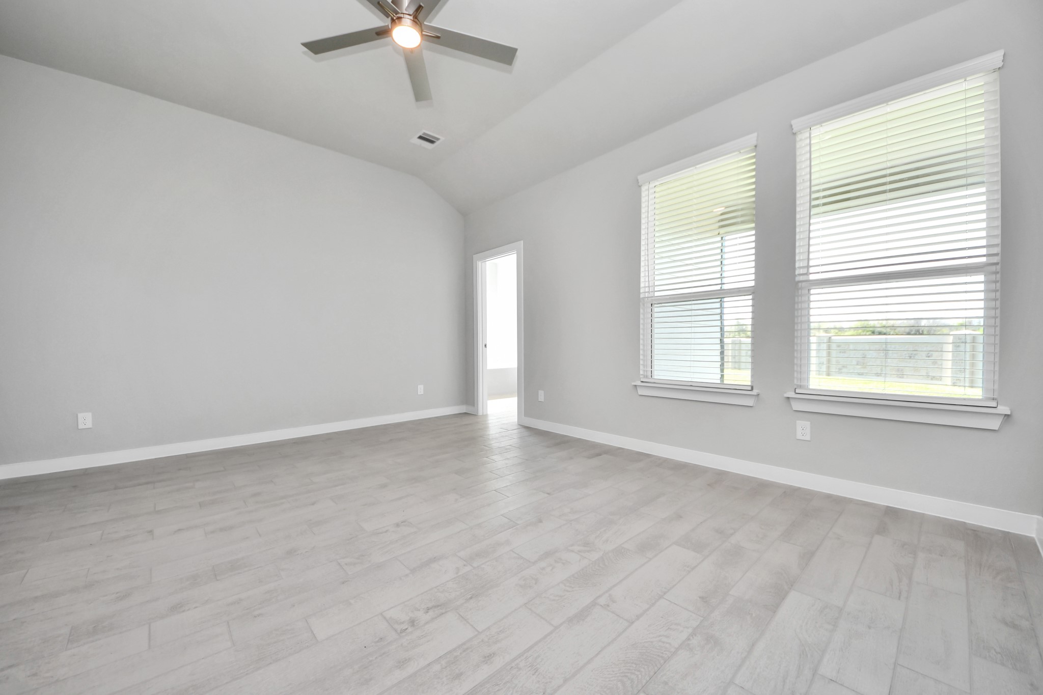 2910 Burris Park Drive Spring, TX 77373 - Photo 18 of 34 Come and unwind after a long day in this magnificent primary suite! This spacious room features beautiful flooring, warm paint, high ceilings and large windows with privacy blinds. Sample photo of completed home with similar floor plan. Actual colors and selections may vary.
