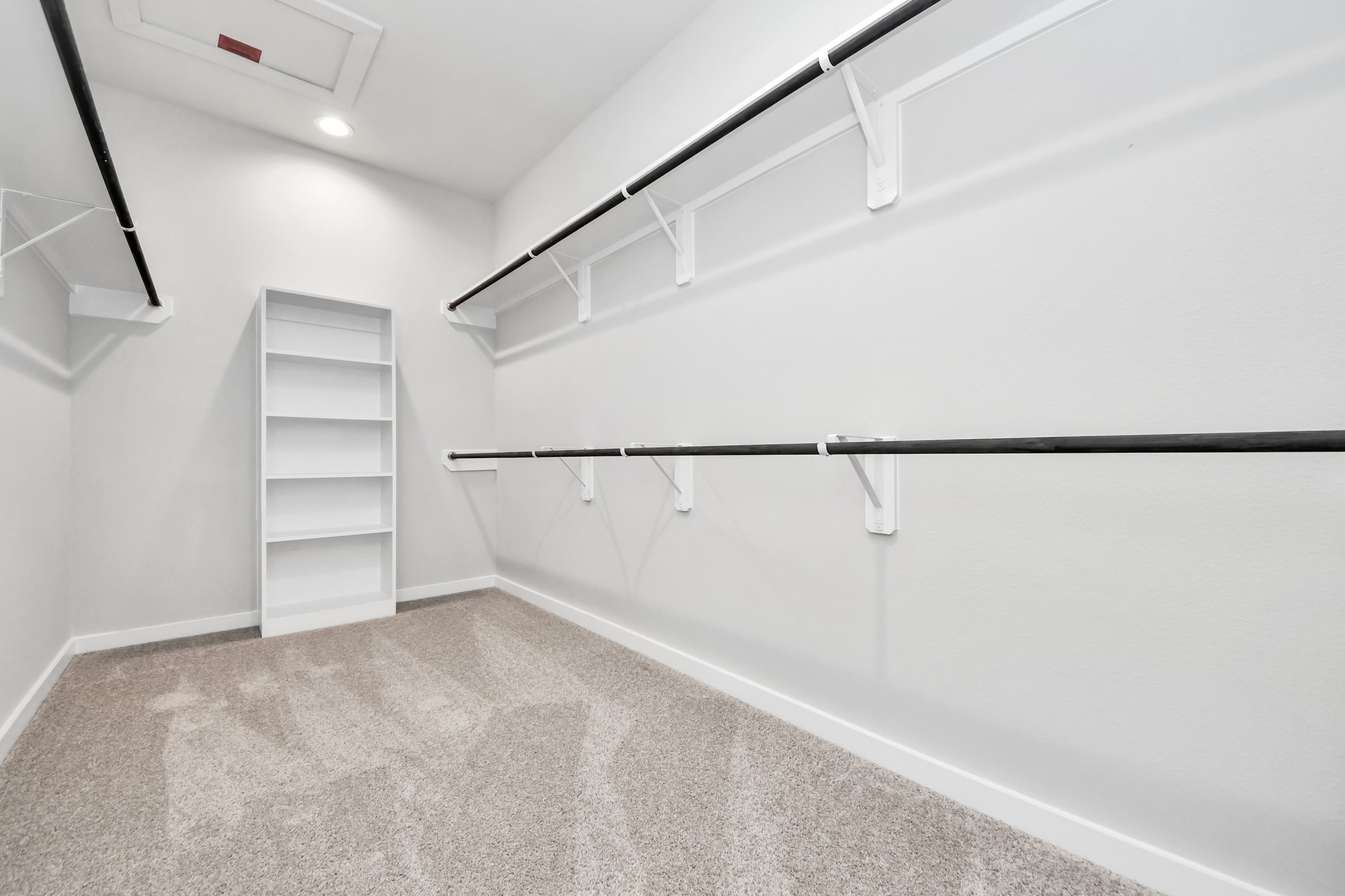 2910 Burris Park Drive Spring, TX 77373 - Photo 23 of 34 Walk-in closet that epitomizes luxury and practicality. This generously sized space features built-in shelving, offering abundant room for impeccable organization. High ceilings and recessed lighting create a bright and welcoming ambiance. Sample photo of completed home with similar floor plan. Actual colors and selections may vary.