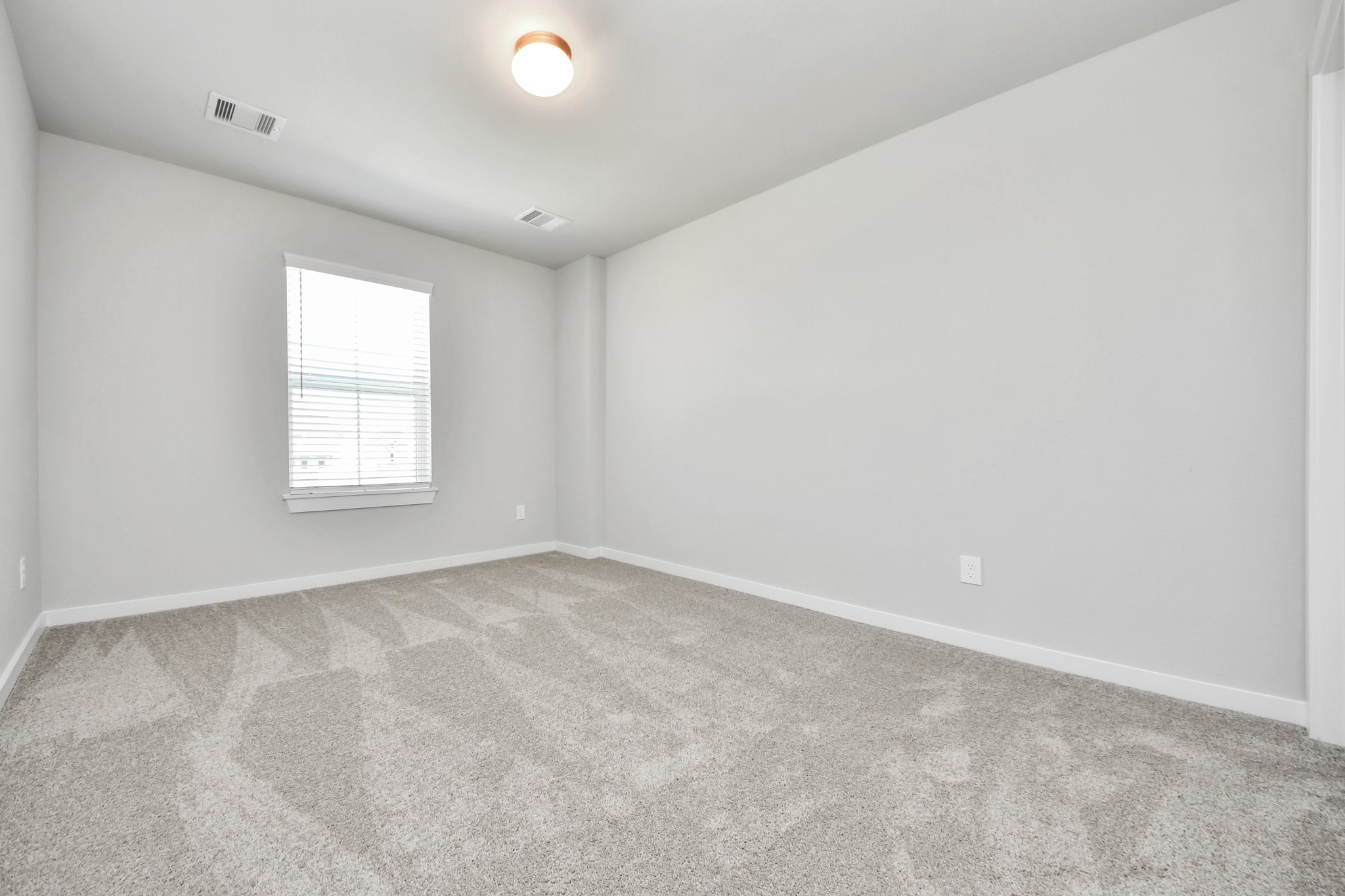 2910 Burris Park Drive Spring, TX 77373 - Photo 28 of 34 Secondary bedroom features plush carpeting, large windows that let in plenty of natural light, bright paint, and spacious closets. Sample photo of completed home with similar floor plan. Actual colors and selections may vary.