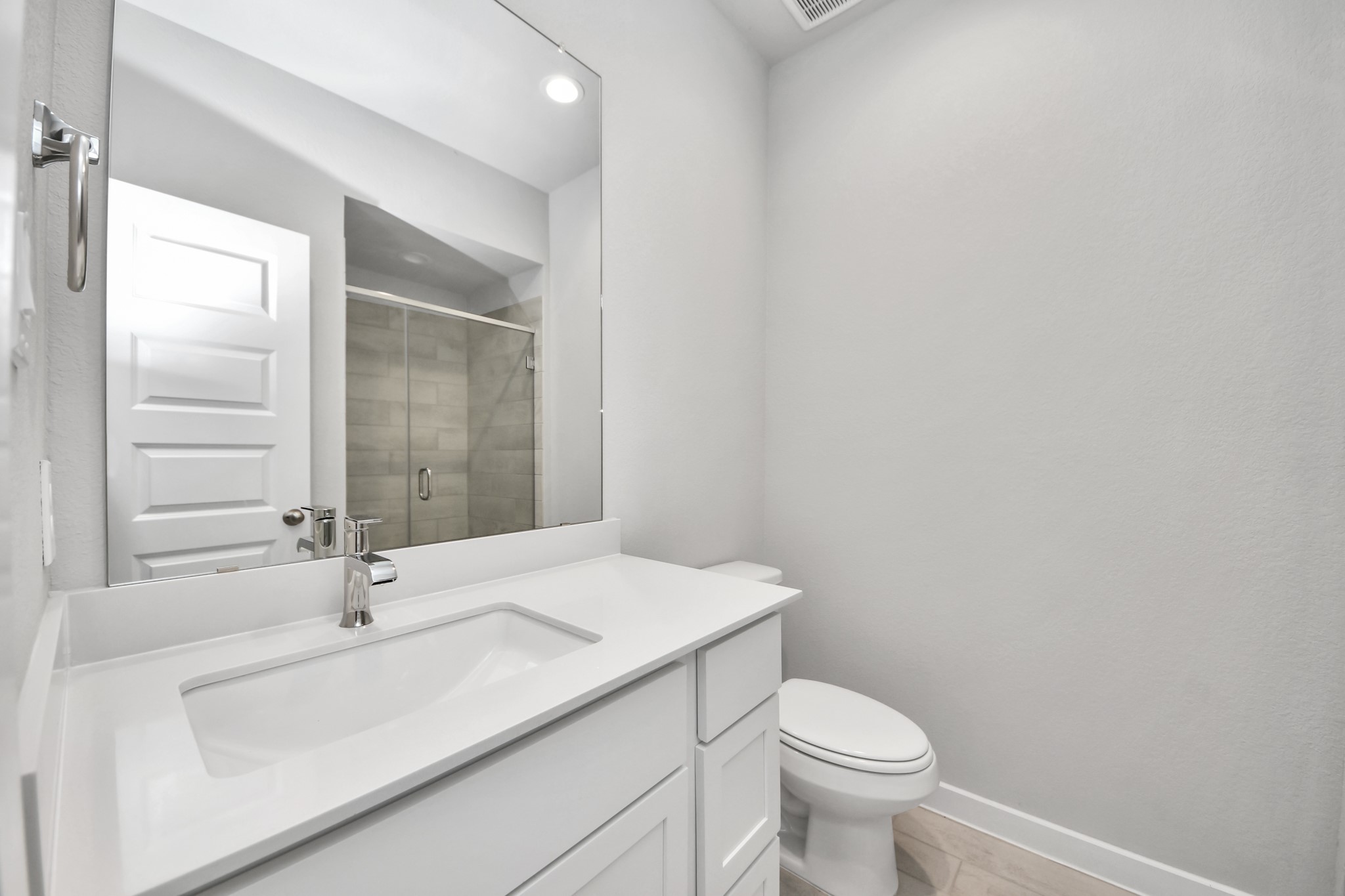 2910 Burris Park Drive Spring, TX 77373 - Photo 4 of 34 Secondary bath features tile flooring, walk-in shower with tile surround, light stained wood cabinets, beautiful light countertop. Sample photo of completed home with similar floor plan. Actual colors and selections may vary.