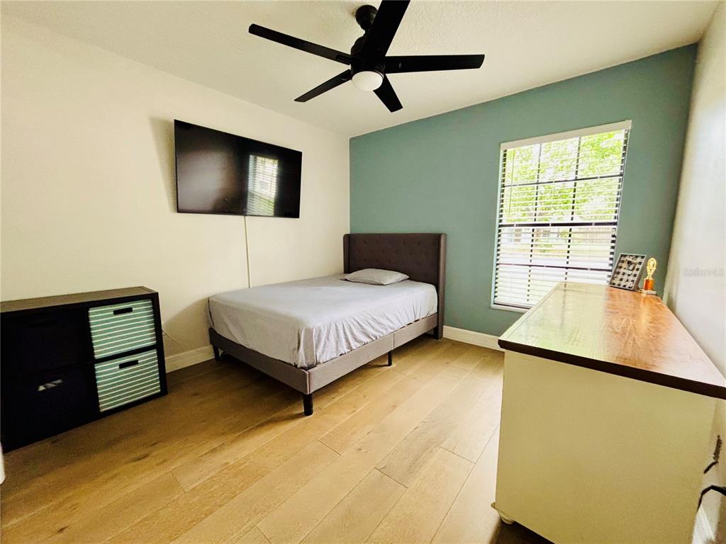 1045 Shaffer Trail Oviedo, FL 32765 - Photo 10 of 30 a bedroom with a bed and a flat screen tv