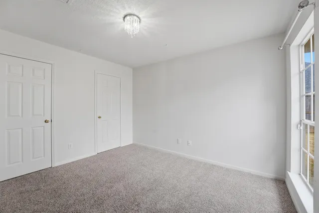 a view of an empty room and a window