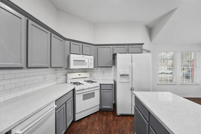 a kitchen with a white cabinets and white appliances
