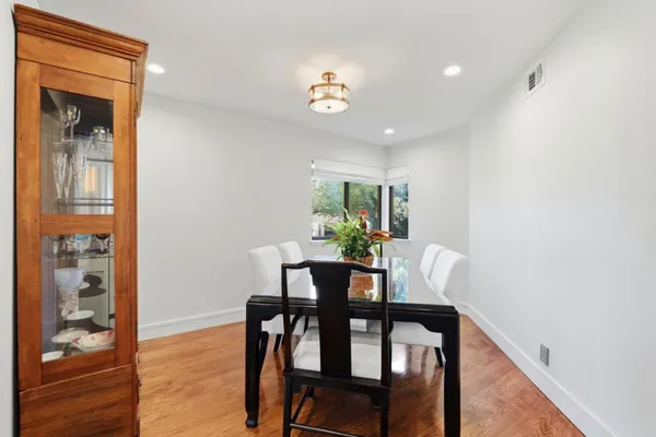 a view of a dining room with furniture and wooden floor