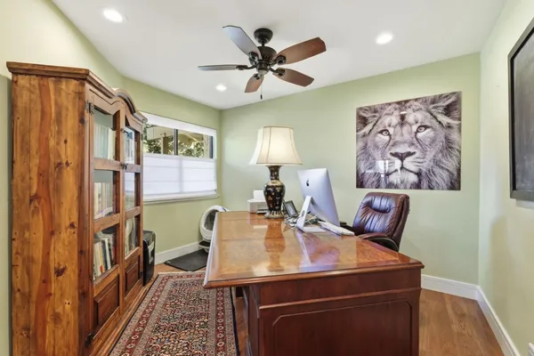 a view of a dining room with furniture and a chandelier