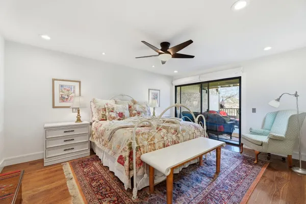 a bed room with a bed window and a chair
