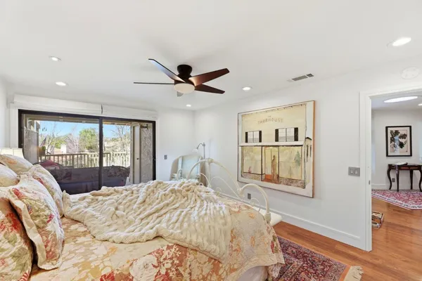 a bedroom with a large bed and a large window