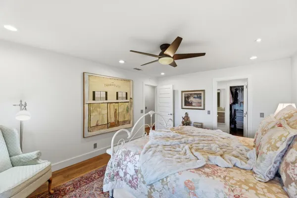 a bedroom with a large bed and a window