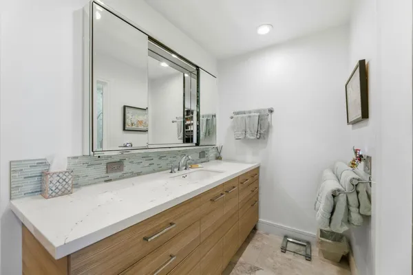 a bathroom with a sink and a mirror