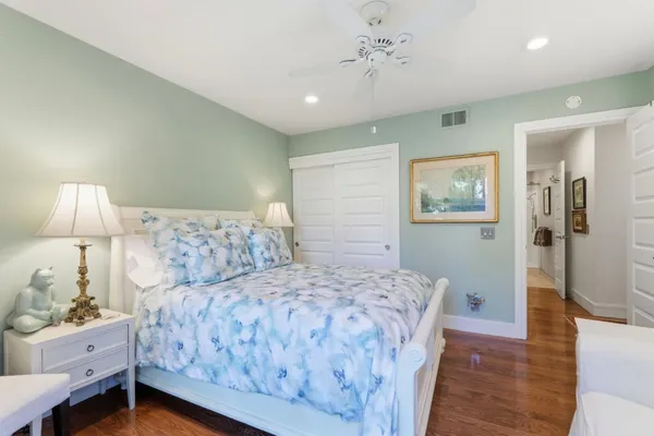 a bedroom with a large bed and a chandelier