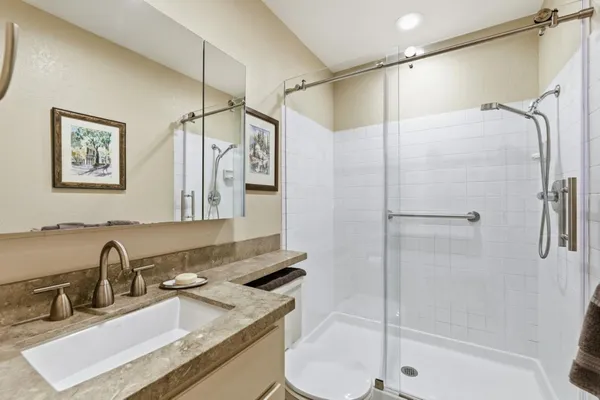 a bathroom with a sink double vanity and shower