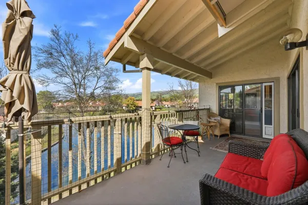 a view of balcony with chairs and couches
