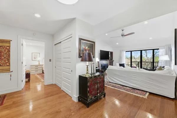 a bedroom with a bed windows and flat screen tv