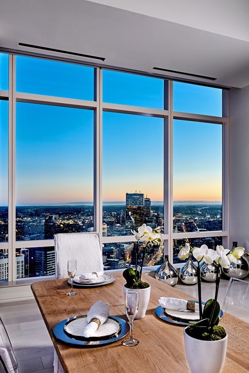 1 Franklin Street, Unit PH4E Boston, MA 02110 - Photo 13 of 30 a living room with furniture kitchen view and large windows