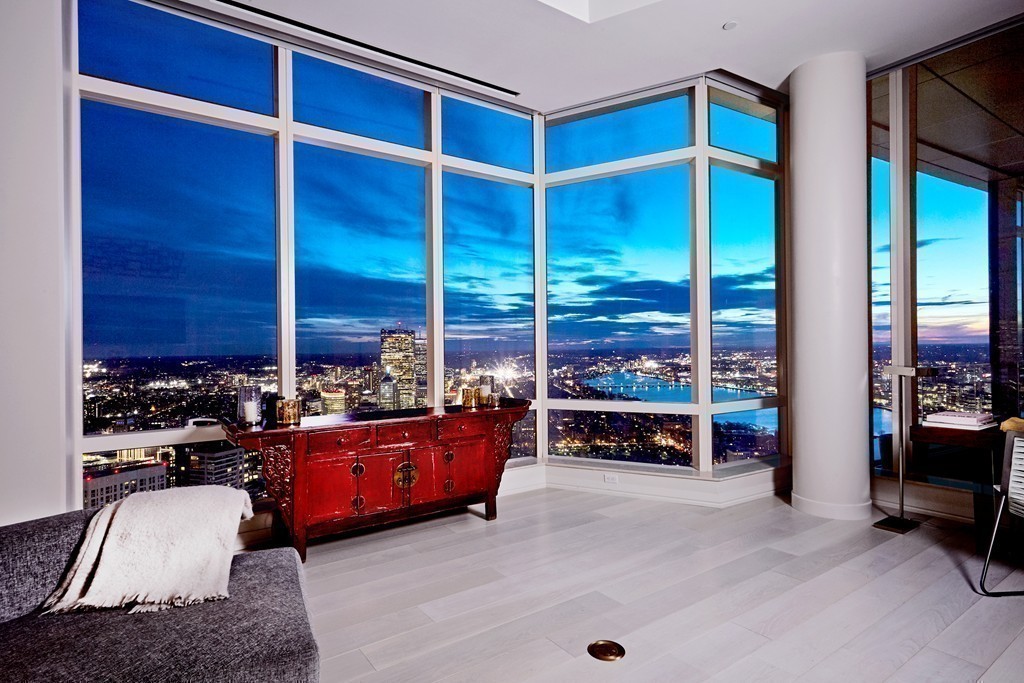 1 Franklin Street, Unit PH4E Boston, MA 02110 - Photo 15 of 30 a living room with furniture gym equipment and a large window