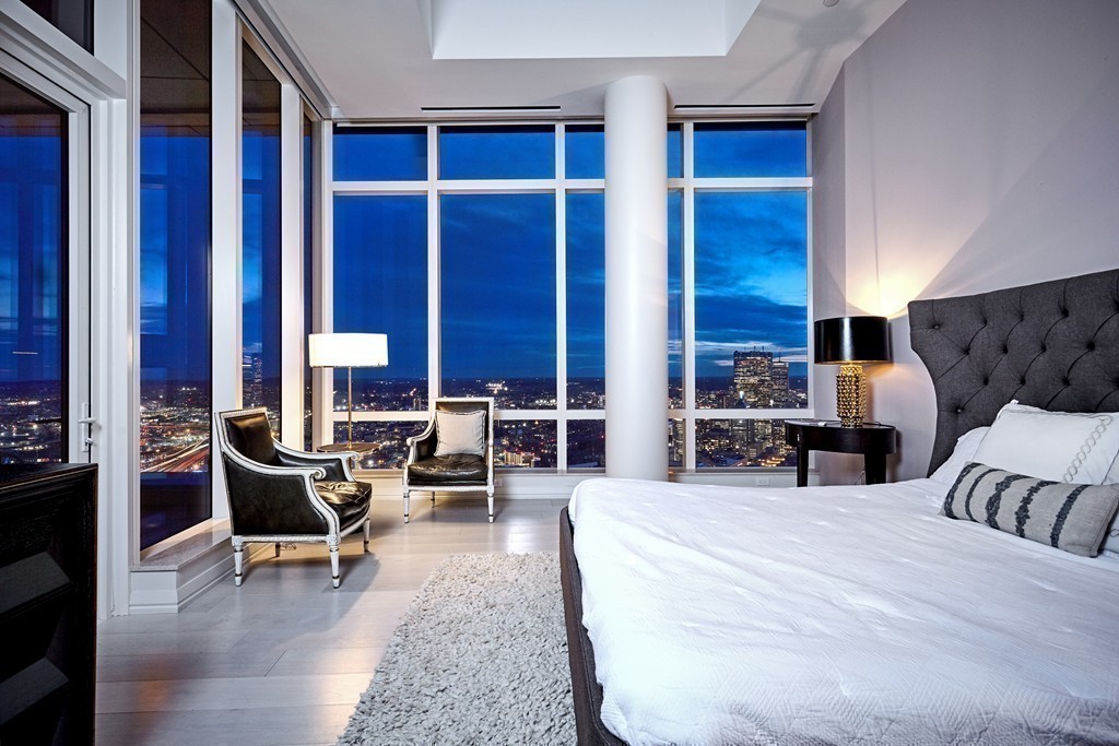 1 Franklin Street, Unit PH4E Boston, MA 02110 - Photo 16 of 30 a living room with furniture and wooden floor