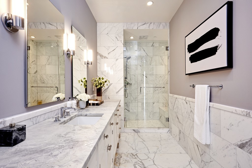 1 Franklin Street, Unit PH4E Boston, MA 02110 - Photo 18 of 30 a bathroom with a granite countertop sink a mirror and shower
