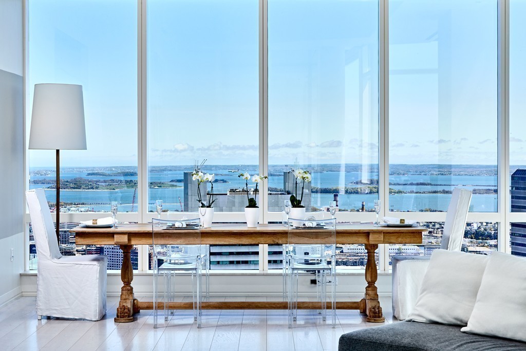 1 Franklin Street, Unit PH4E Boston, MA 02110 - Photo 7 of 30 a living room with stainless steel appliances kitchen island granite countertop a stove and a sink