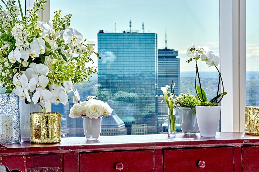 1 Franklin Street, Unit PH4E Boston, MA 02110 - Photo 9 of 30 a potted plant sitting on a wooden table and a chair