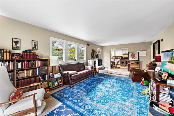a living room with furniture and a book shelf