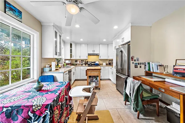 a dining room filled counter top space and a window