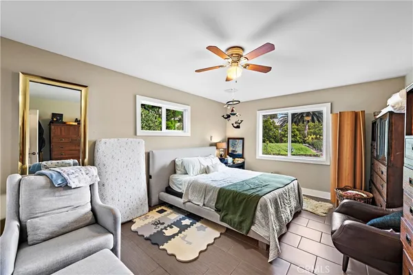 a bedroom with a bed couch and window
